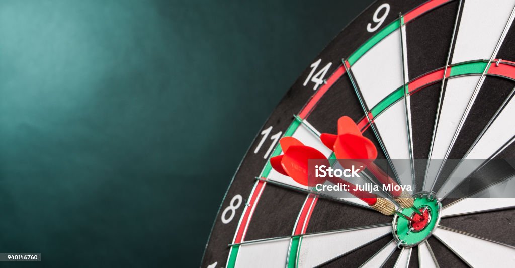 Two Darts in the center of the target dartboard Two Darts in the center of the target dartboard on a colorful background Darts Stock Photo