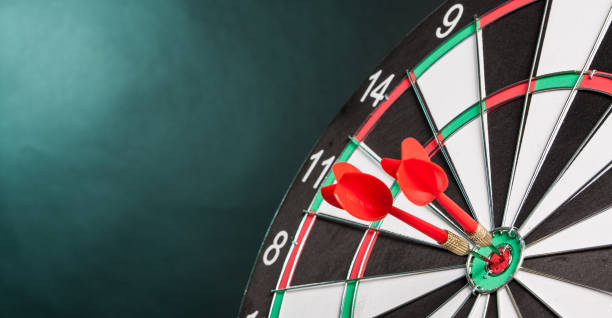 Two Darts in the center of the target dartboard Two Darts in the center of the target dartboard on a colorful background darts photos stock pictures, royalty-free photos & images
