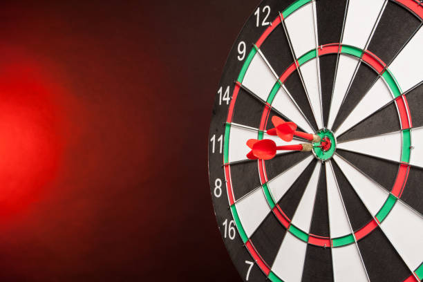 istock Two Darts in the center of the target dartboard 940146912