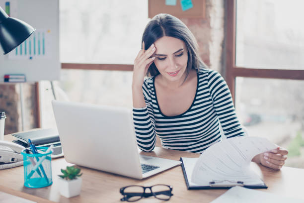 istock Attractive female manager analyzing  new partnership agreement while sitting at the table 940147326
