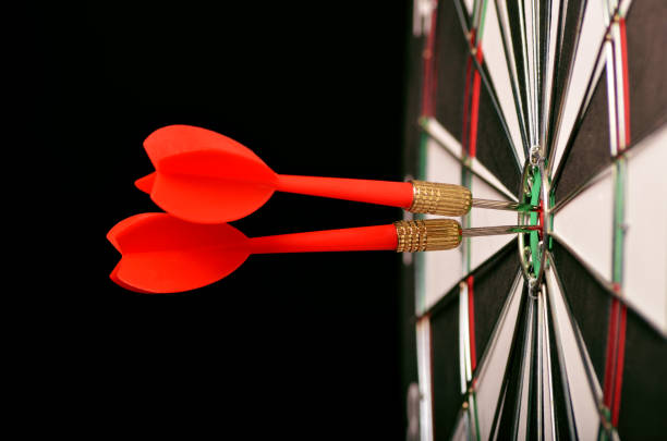 istock Two Darts in the center of the target dartboard 940147368