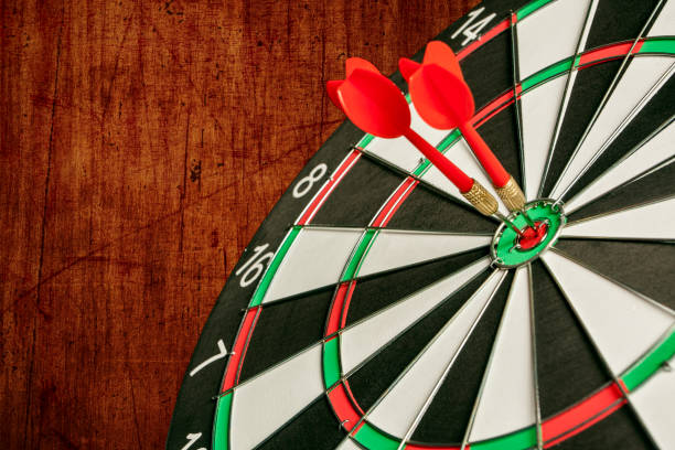 istock Two Darts in the center of the target dartboard 940147792
