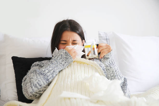 istock sick woman having herbal tea 940148514