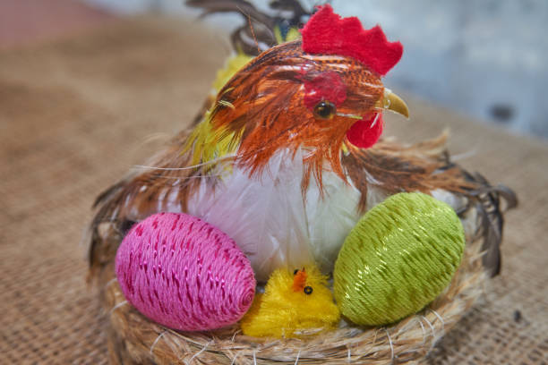 istock Easter chick decoration in a nest hatches colorful easter eggs 940153532