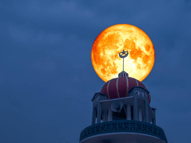 istock super full blood moon back top of mosque night sky 940153662