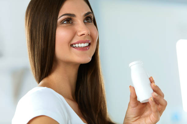 istock Diet Nutrition. Beautiful Smiling Woman Drinking Yoghurt Indoors 940154302