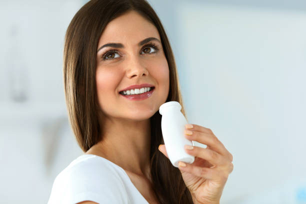 istock Diet Nutrition. Beautiful Smiling Woman Drinking Yoghurt Indoors 940154364