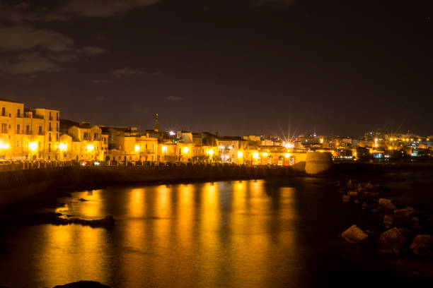 istock Ortygia Island's Coast by Night in Syracuse 940157486