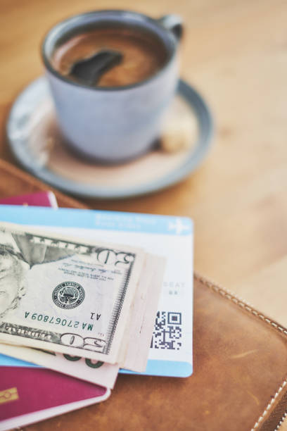 istock Preparing for a trip, plane ticket, money and wallet on desk 940159264