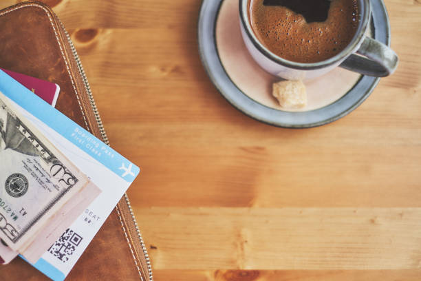 istock Preparing for a trip, plane ticket, money and wallet on desk 940159266