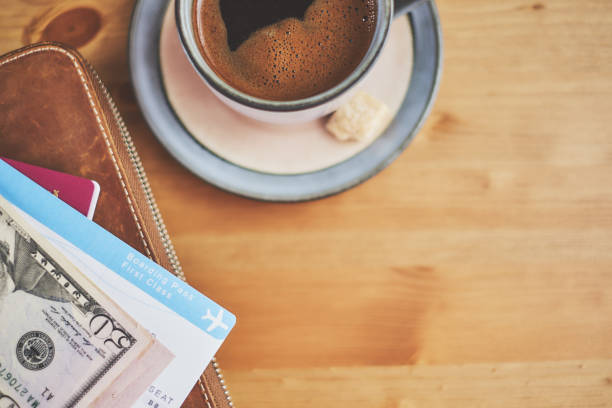 istock Preparing for a trip, plane ticket, money and wallet on desk 940159272