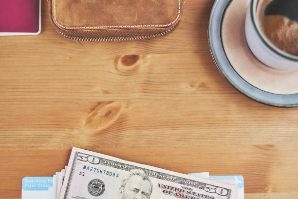 istock Preparing for a trip, plane ticket, money and wallet on desk 940159290
