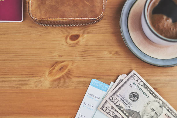 istock Preparing for a trip, plane ticket, money and wallet on desk 940159292