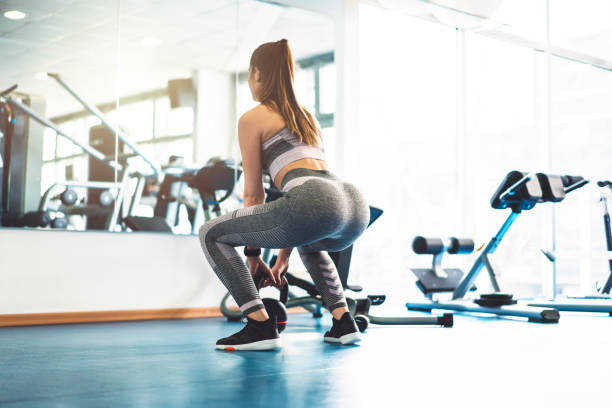 istock Strong woman exercising at the gym with kettle bell 940162942
