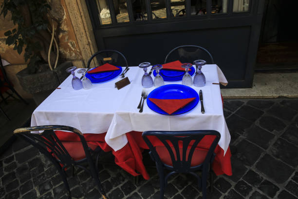 istock Glasses, spoons, plates and forks on the table in restaurant 940163002