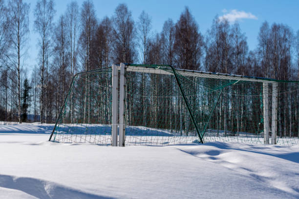 istock Two football goals standing against each other in deep snow 940167442