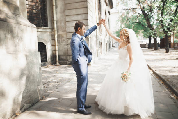 istock Beautiful caucasian wedding couple just married and dancing their first dance 940171764