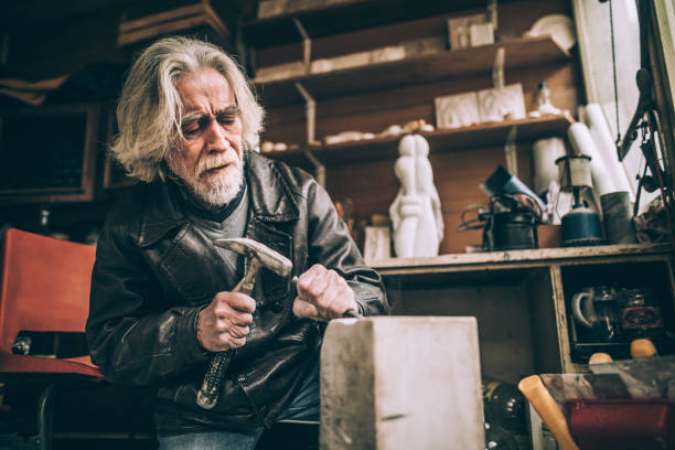 istock Senior artist working with marble at his workshop 940181194