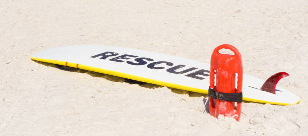 a surfboard and life guard equipment - surf rescue imagens e fotografias de stock