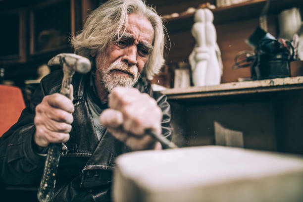 istock Senior artist working with marble at his workshop 940181468