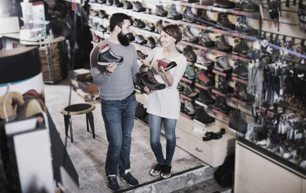 istock Couple choosing sneakers in store 940181796