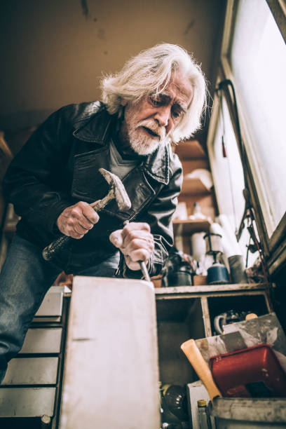 istock Senior artist working with marble at his workshop 940182268