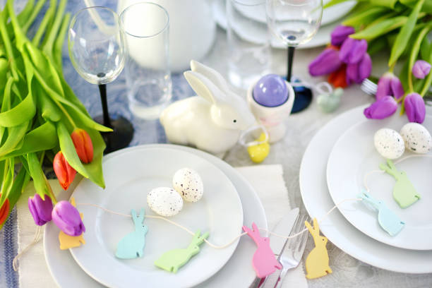 istock Beautiful table setting with crockery and flowers for Easter celebration 940182814