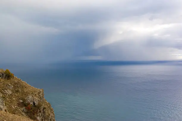 Photo of Cliff top and clouded sky over the ocean.