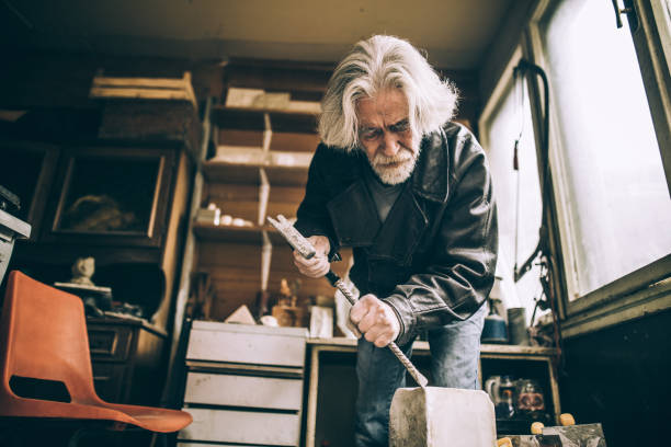 istock Senior sculptor working at his garage 940185168