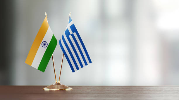 istock Indian And Greek Flag Pair On A Desk Over Defocused Background 940185712