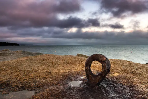 Rusted Eyebolt Looks Out to the Atlantic Ocean at Sunset in Rockland, Maine