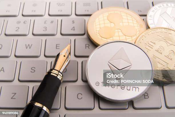 Stock Of Physical Bitcoins Btc Bitcoin Ethereum Litecoins Ripple Gold And Silver Coins Cryptocurrency Concept Stock Photo - Download Image Now