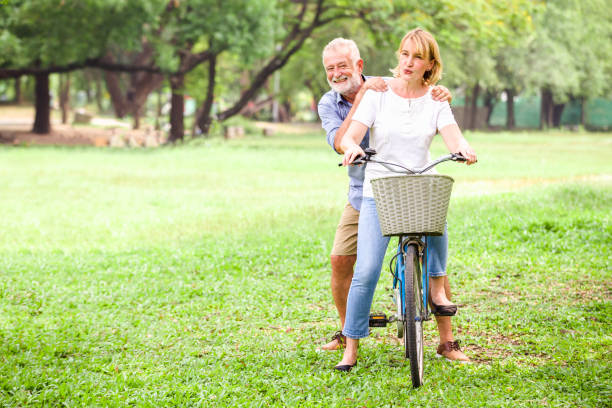 istock Senior couple walking their bike 940192382