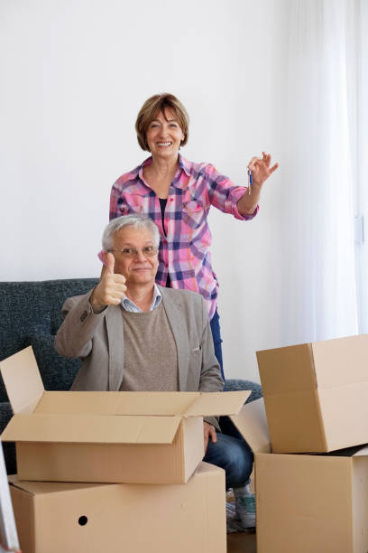 istock Senior couple moving into a new apartment 940192630
