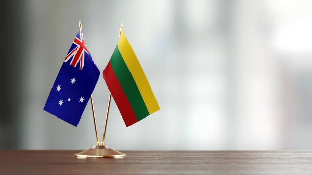 istock Australian And Lithuanian Flag Pair On A Desk Over Defocused Background 940193078