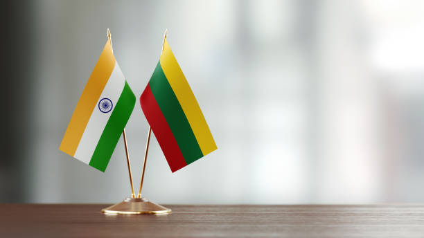 istock Indian And Lithuanian Flag Pair On A Desk Over Defocused Background 940193326