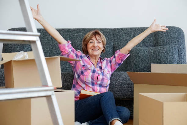 Senior woman moving into a new apartment stock photo