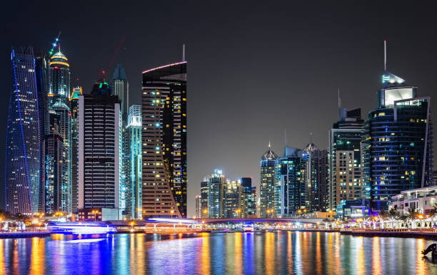 istock Skyline of Dubai Marina at night reflected in water 940197664