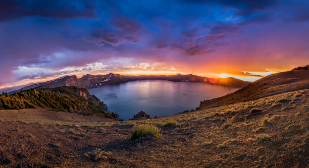 istock Sunburst Panorama Over Crater Lake 940198010