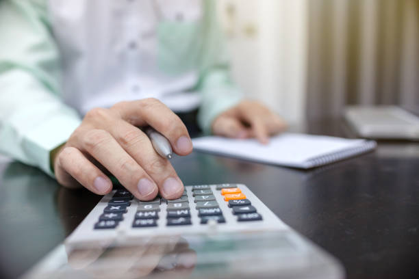 istock Businessman using calculator financial business calculation 940198070
