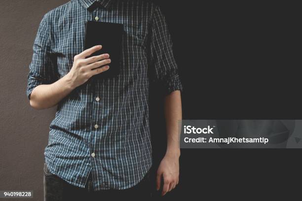 Man Holding Holy Bible Prayer Concept For Faith Spirituality And Religion Gray Background Stock Photo - Download Image Now
