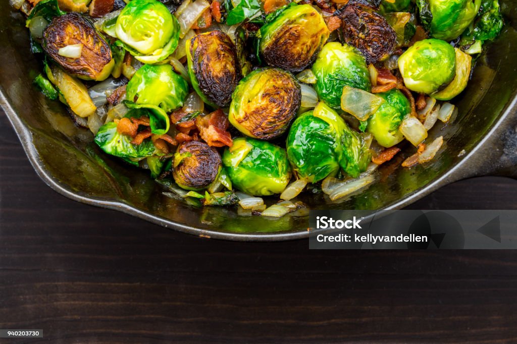 Wide Half View of Roasted Brussels Sprouts and Bacon Wide Half View of Roasted Brussels Sprouts and Bacon in cast iron skillet Brussels Sprout Stock Photo