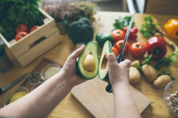 healthy eating concept - vegetable men cutting adult imagens e fotografias de stock