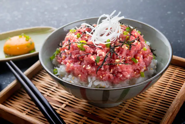 Photo of Raw tuna and onion with rice in Japanese style.