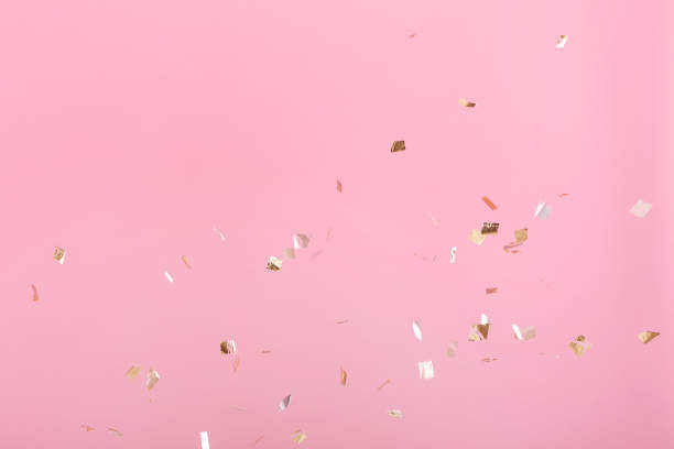 istock Golden confetti on pink background 940206994