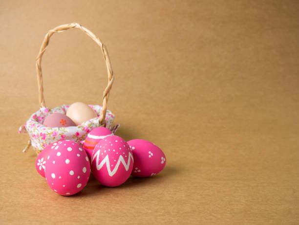 istock Easter eggs in a basket weave wood on the left corner on a brown background. 940217440
