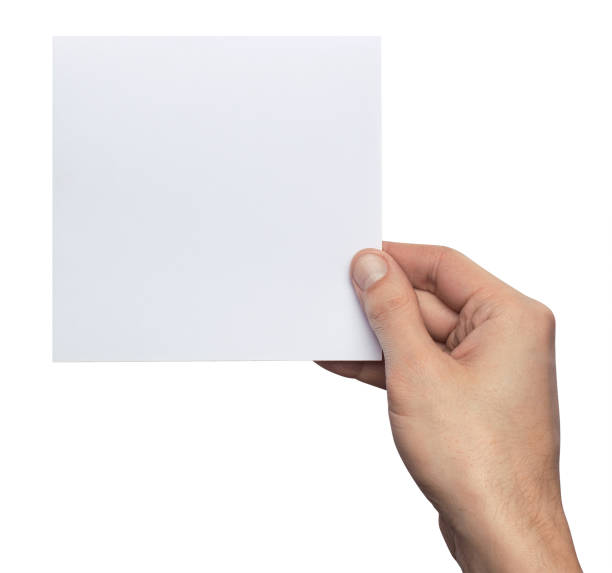 istock Mockup square empty blank white postcard holds the man in his hand. Isolated on a white background 940218040