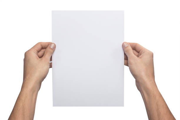 istock Mockup A4 letter vertical empty blank white holds the man in his hand. Isolated on a white background 940218090