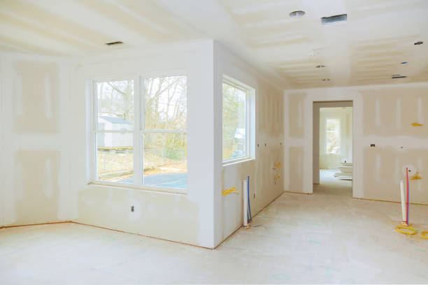 istock Interior construction of housing project with drywall installed and patched without painting applied 940222690