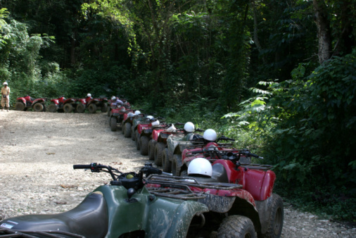 Row of four wheelers in the jungled mountains of Jamaica. 